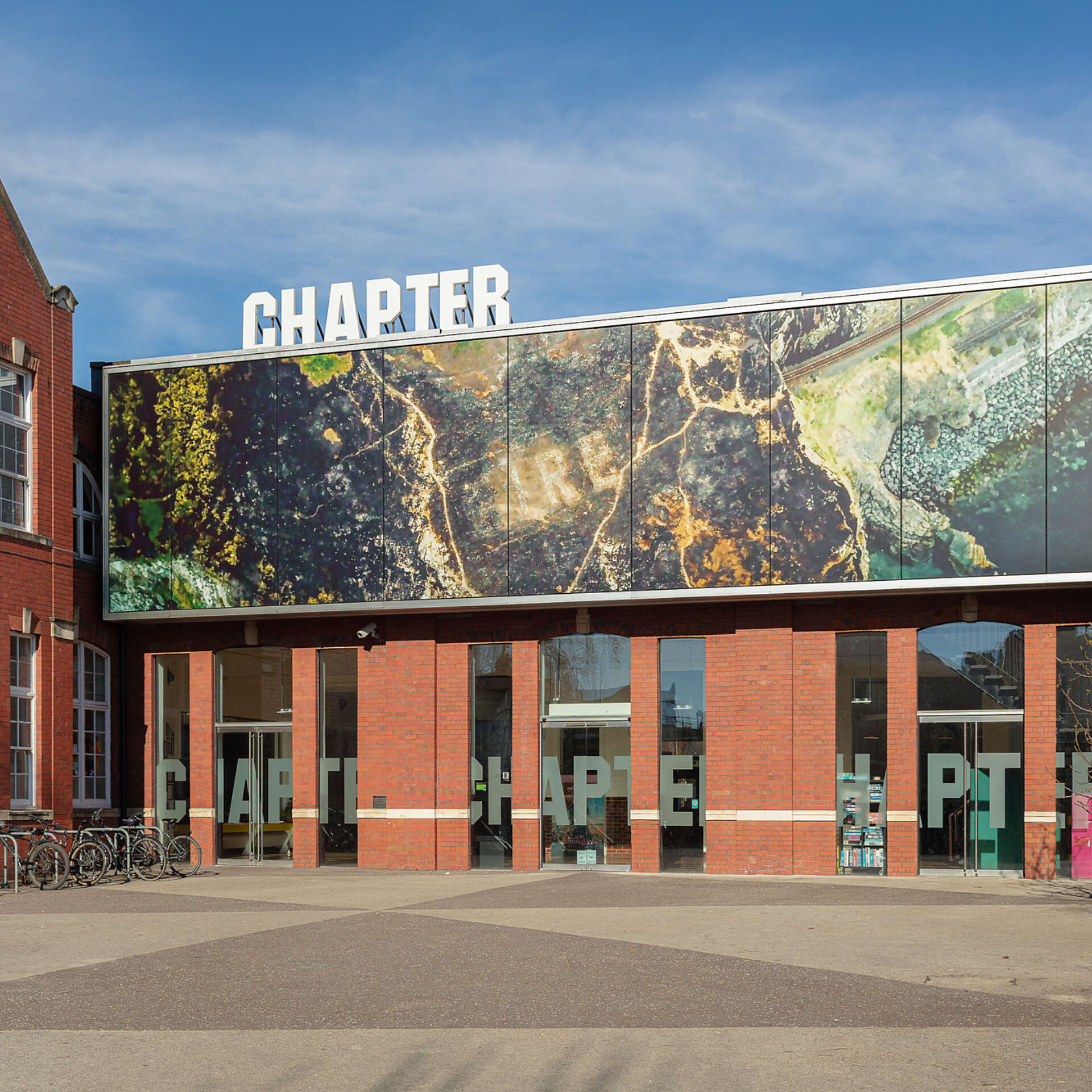 The main entrance of Chapter in the distance, with some plants in the foreground.